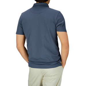 Back view of a man in a Slate Blue Cotton Sunspel Riviera Polo Shirt.