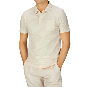 A man dressed in an Undyed Cotton Riviera Polo Shirt by Sunspel.
