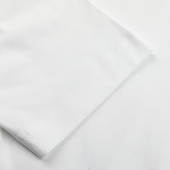 Close-up of the seam on a Sunspel White Supima Cotton Relaxed Fit T-shirt, highlighting the intricate stitching detail at the edge.