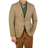 A man wearing a Beige Houndstooth Wool Tweed Vesuvio Blazer by Tagliatore.