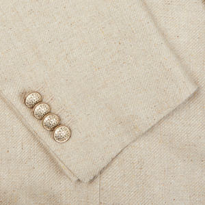 A close up of a slim fit Beige Melange Silk Twill Vesuvio Blazer by Tagliatore with buttons.