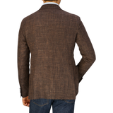 A man seen from behind wearing a Tagliatore Dark Brown Melange Wool Linen Silk Blazer and blue denim jeans.
