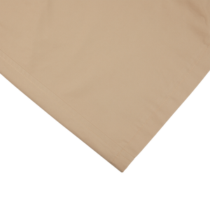 A khaki beige Tagliatore pillowcase on top of a white surface, providing a slim fit.