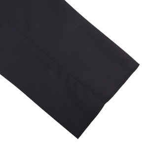 A close up of Tagliatore Midnight Navy Super 110s Wool Pleat Trousers on a white surface.