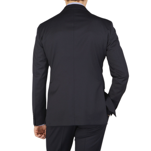 The back view of a man wearing a Tagliatore Midnight Navy Super 110s Wool Suit Jacket made from worsted semi-shiny 100% wool fabric.
