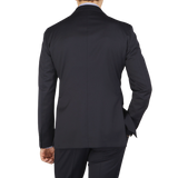 The back view of a man wearing a Tagliatore Midnight Navy Super 110s Wool Suit Jacket made from worsted semi-shiny 100% wool fabric.