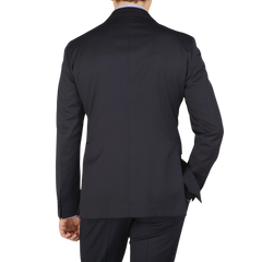 The back view of a man wearing a Tagliatore Midnight Navy Super 110s Wool Suit Jacket made from worsted semi-shiny 100% wool fabric.