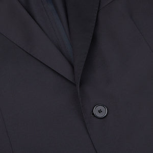A close up of a black suit with the Tagliatore Midnight Navy Super 110s Wool Suit Jacket featuring slim cut and worsted semi-shiny 100% wool fabric, adorned with buttons.