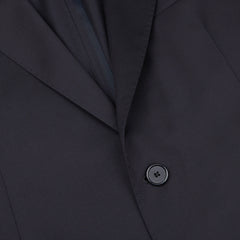 A close up of a black suit with the Tagliatore Midnight Navy Super 110s Wool Suit Jacket featuring slim cut and worsted semi-shiny 100% wool fabric, adorned with buttons.