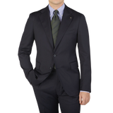 A man wearing a Tagliatore Midnight Navy Super 110s Wool Suit Jacket with a slim cut and tie.