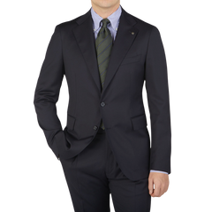 A man wearing a Tagliatore Midnight Navy Super 110s Wool Suit Jacket with a slim cut and tie.