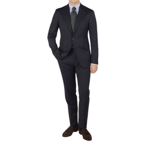 A man wearing a Tagliatore Midnight Navy Super 110s Wool Suit Jacket and tie made from worsted semi-shiny 100% wool fabric.