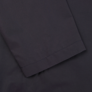 A close up of the pocket of a Tagliatore navy blue cotton nylon trench coat.