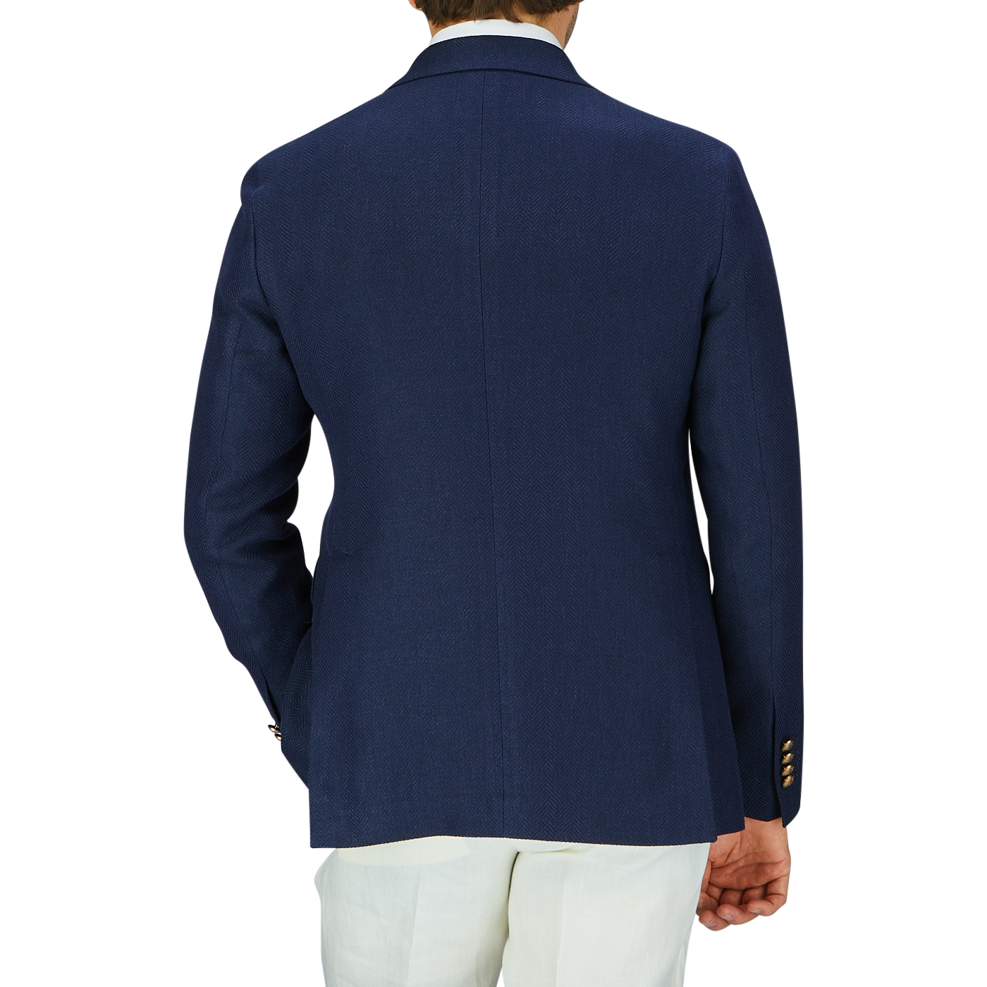 A person from behind wearing a Tagliatore navy blue herringbone cotton linen Vesuvio blazer with peak lapel and white trousers.