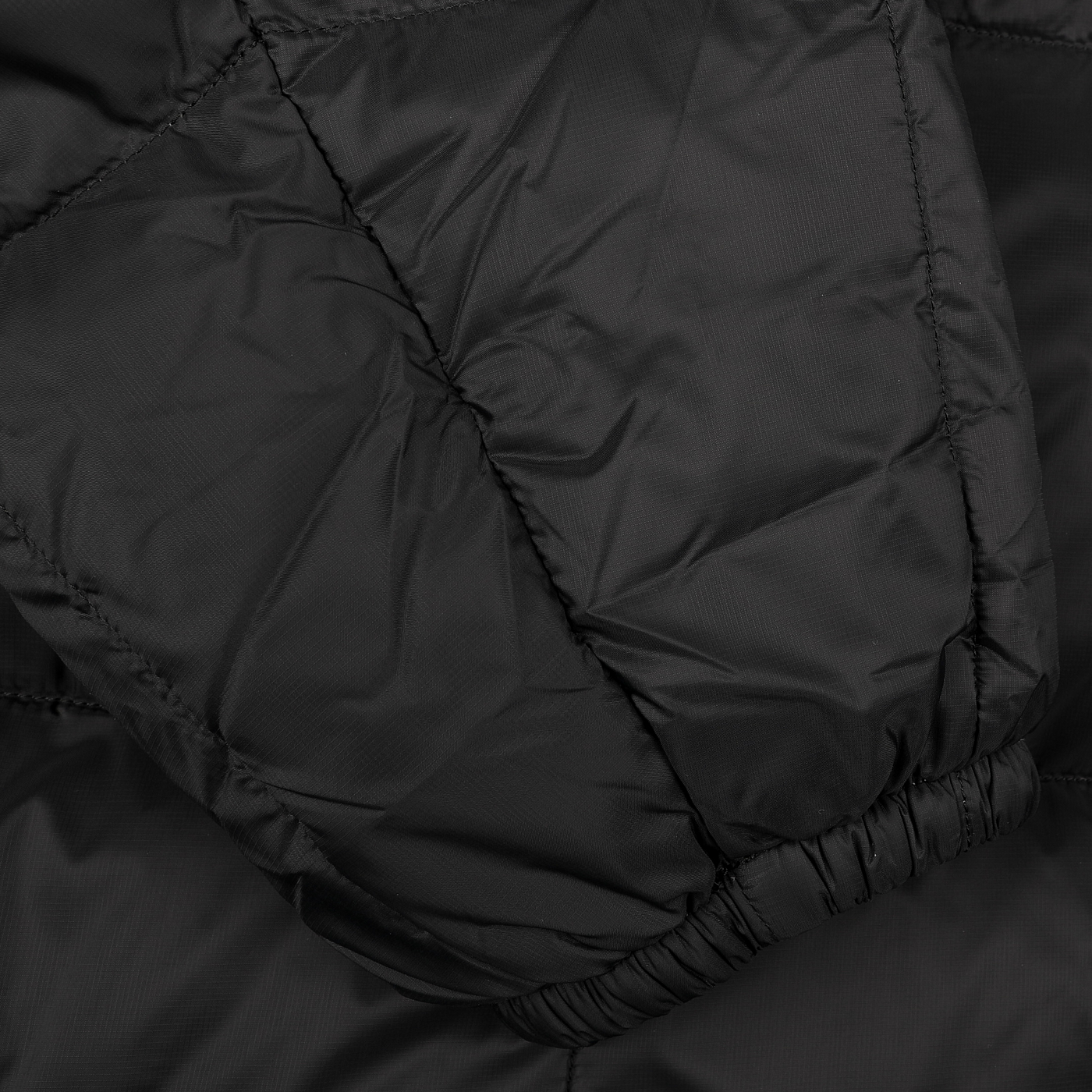 Close-up of the Taion Black Nylon Down Padded Parka showcasing its quilted design, visible stitching, elastic cuffs, and durable nylon outer layer for a stylish look.