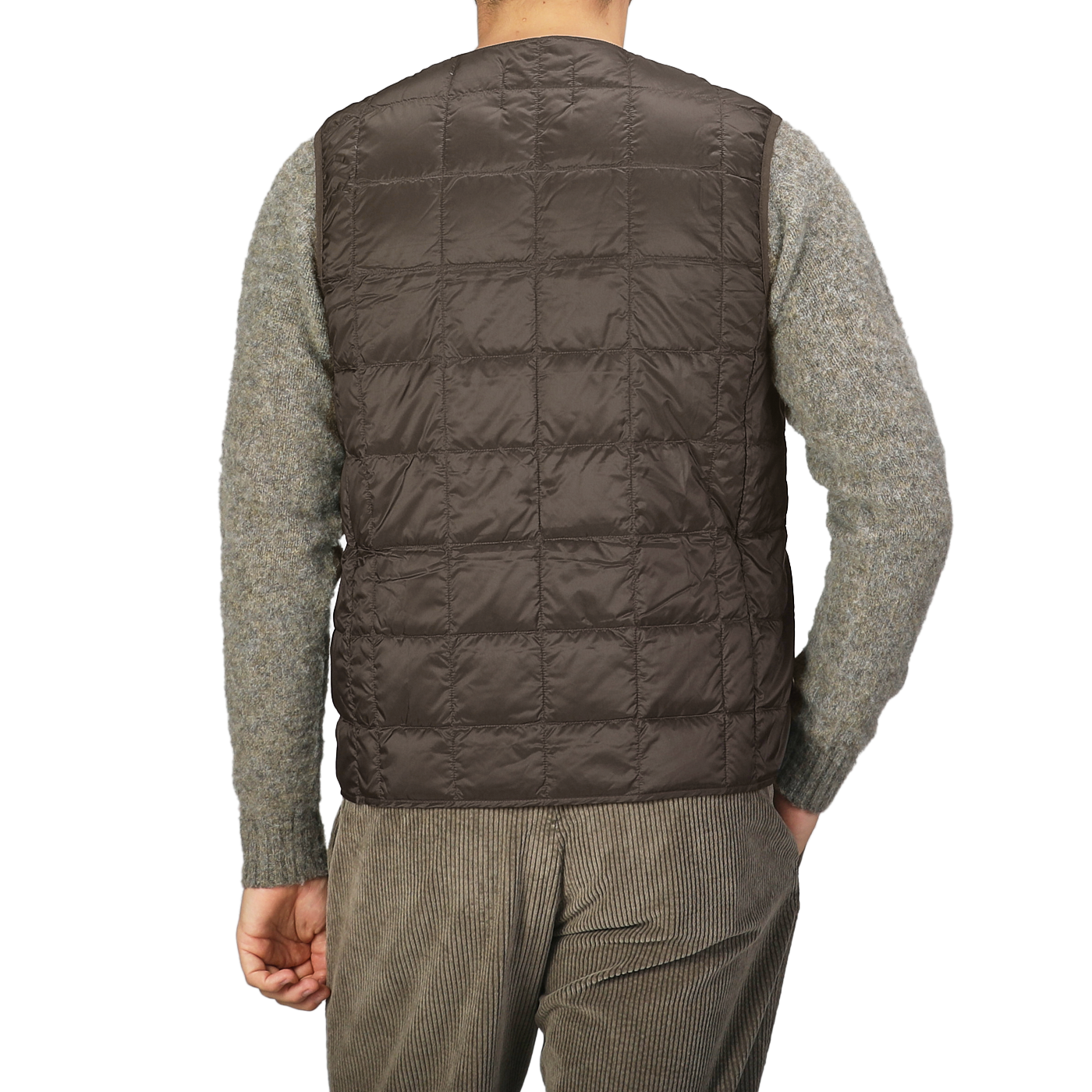 A person is shown from the back wearing a Taion Dark Chocolate Nylon Down Padded Vest over a gray sweater, with its high-density nylon exterior subtly hinting at its comfort.