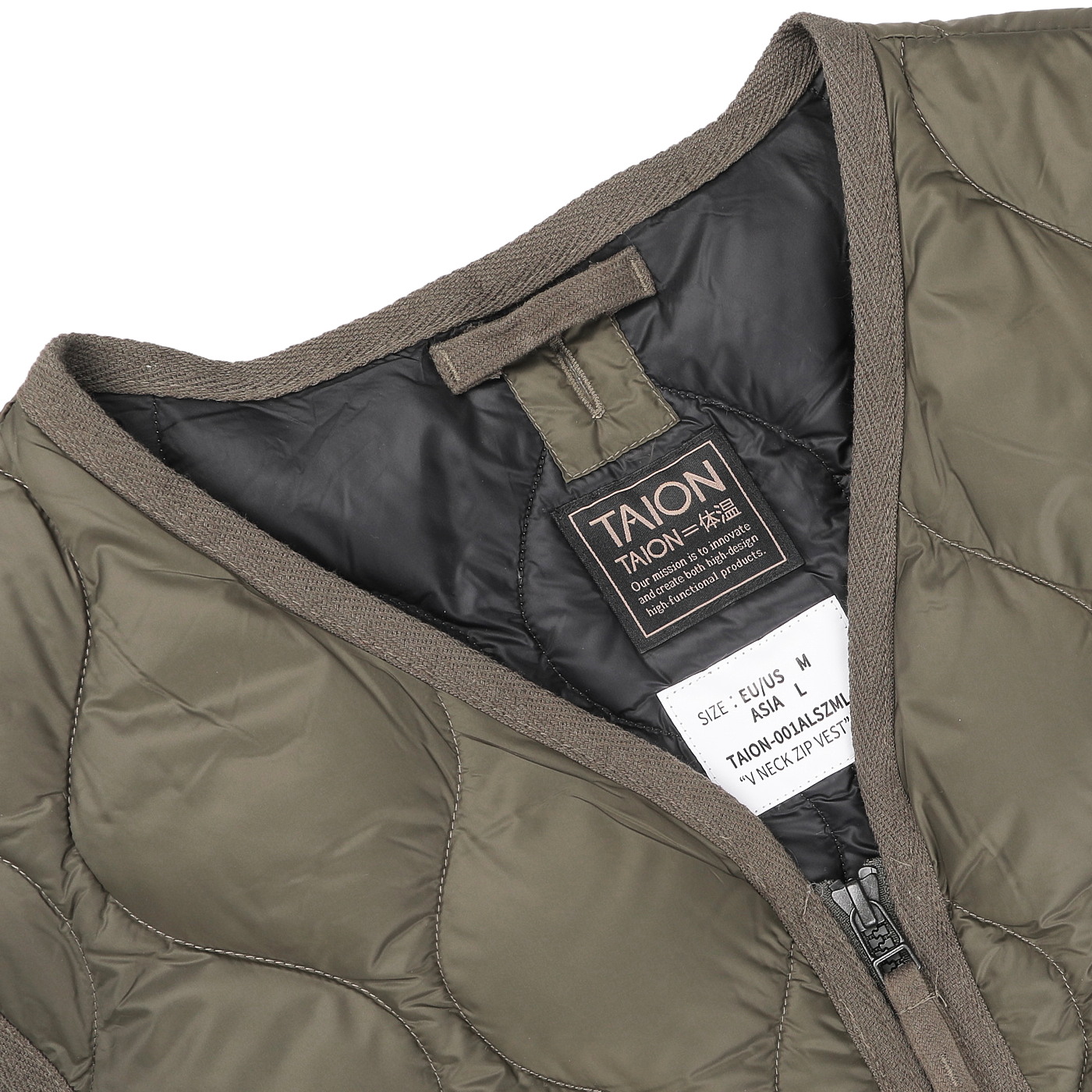 Close-up of a Dark Olive Nylon Down Padded Zip Vest, highlighting its high-density nylon construction with a gray interior, featuring labels displaying the "Taion" brand and size details.