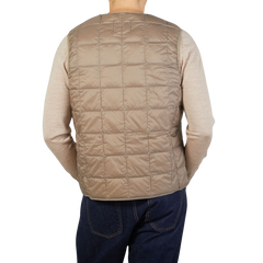 A man wearing a Taion Khaki Beige Nylon Down Padded Vest.