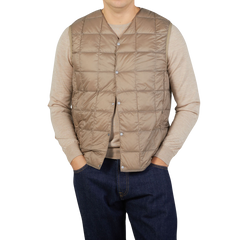 A man wearing a Taion Khaki Beige Nylon Down Padded Vest.