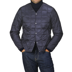 A person wearing the Navy Blue Nylon Down Padded Jacket by Taion, with arms relaxed, stands against a gray background.