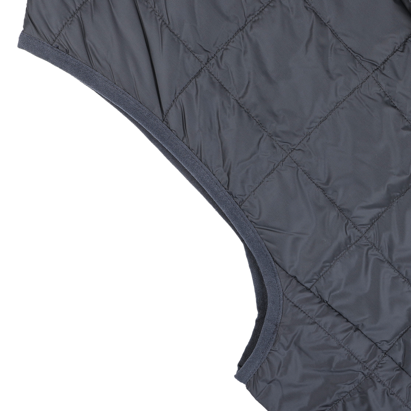 Close-up of the navy blue quilted fabric with visible stitching, shown at an angle, resembling the intricate detail of high-density nylon found in Taion's Navy Blue Nylon Down Padded Vest.