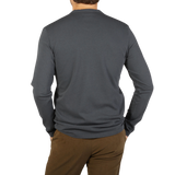 The back view of a man wearing an Asphalt Grey Cotton LS T-Shirt from the Italian heritage clothing brand Tela Genova.