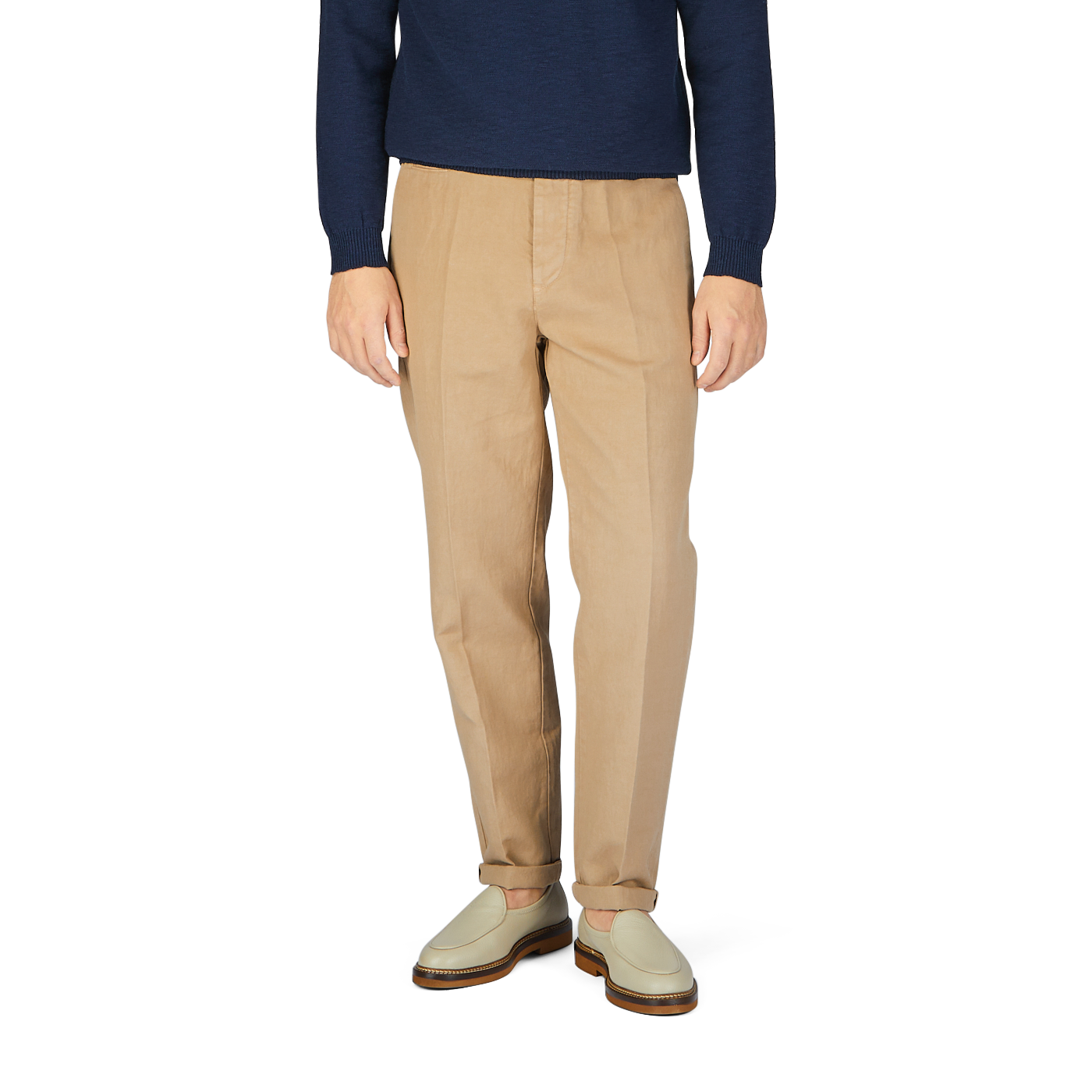 A man wearing Beige Cotton Linen Duilio Trousers from Tela Genova and a navy sweater.