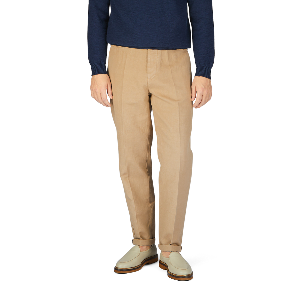 A man wearing Beige Cotton Linen Duilio Trousers from Tela Genova and a navy sweater.