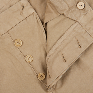 A close up of Tela Genova's Beige Cotton Linen Duilio Trousers with buttons.