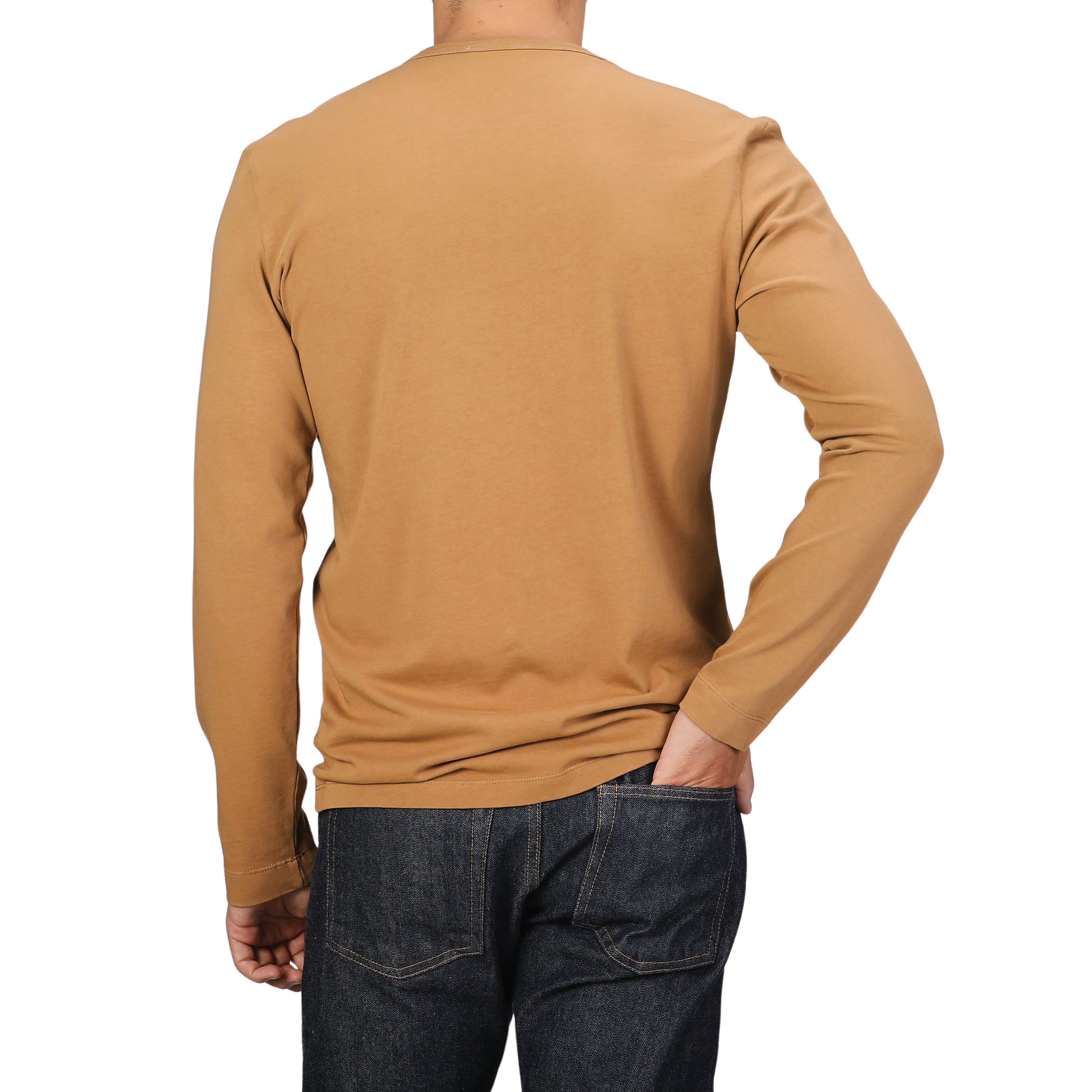 A person wearing a long-sleeve Brick Orange Heavy Organic Cotton LS T-Shirt by Tela Genova and dark jeans with their right hand in their back pocket, facing away from the camera.