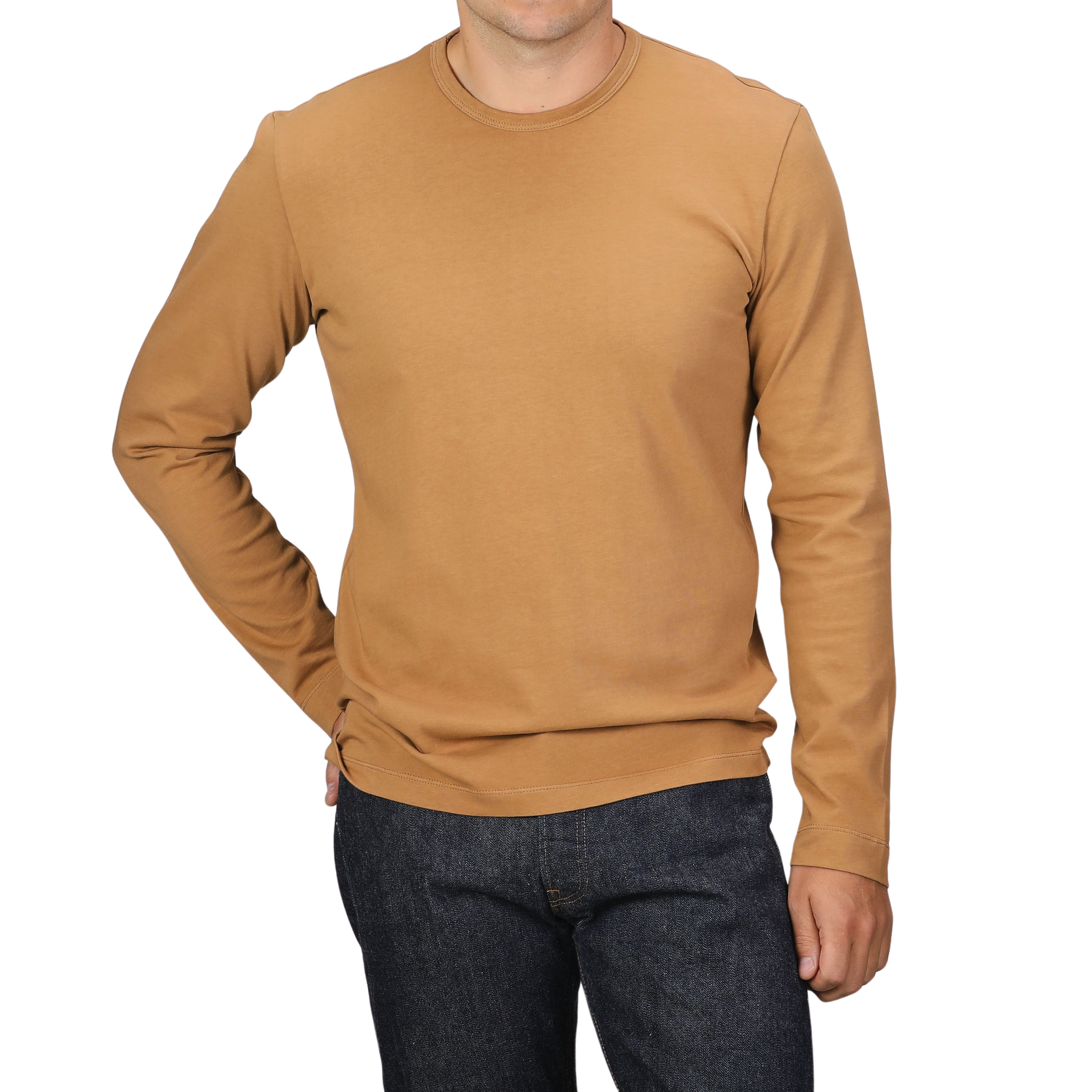 A person wearing a Brick Orange Heavy Organic Cotton Long-Sleeve T-Shirt by Tela Genova and dark jeans stands against a black background.