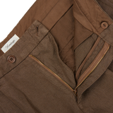 A pair of Tela Genova Brown Linen Damasco Pleated Shorts with zippers on the side.