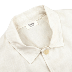 Close-up of an Ecru Pure Linen Camillo Jacket by Tela Genova, with a collar and button-up design, channeling a casual look reminiscent of a vintage overshirt.