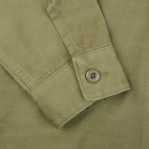 A close up of a Grass Green Greto Cotton Overshirt by Tela Genova with buttons.