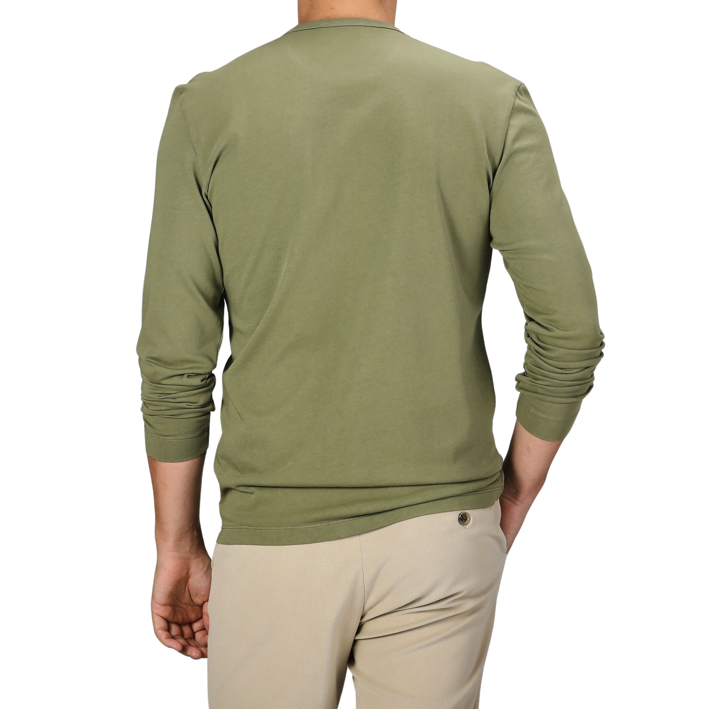 A person in a Tela Genova Grass Green Heavy Organic Cotton LS T-Shirt and beige pants stands with their back to the camera.