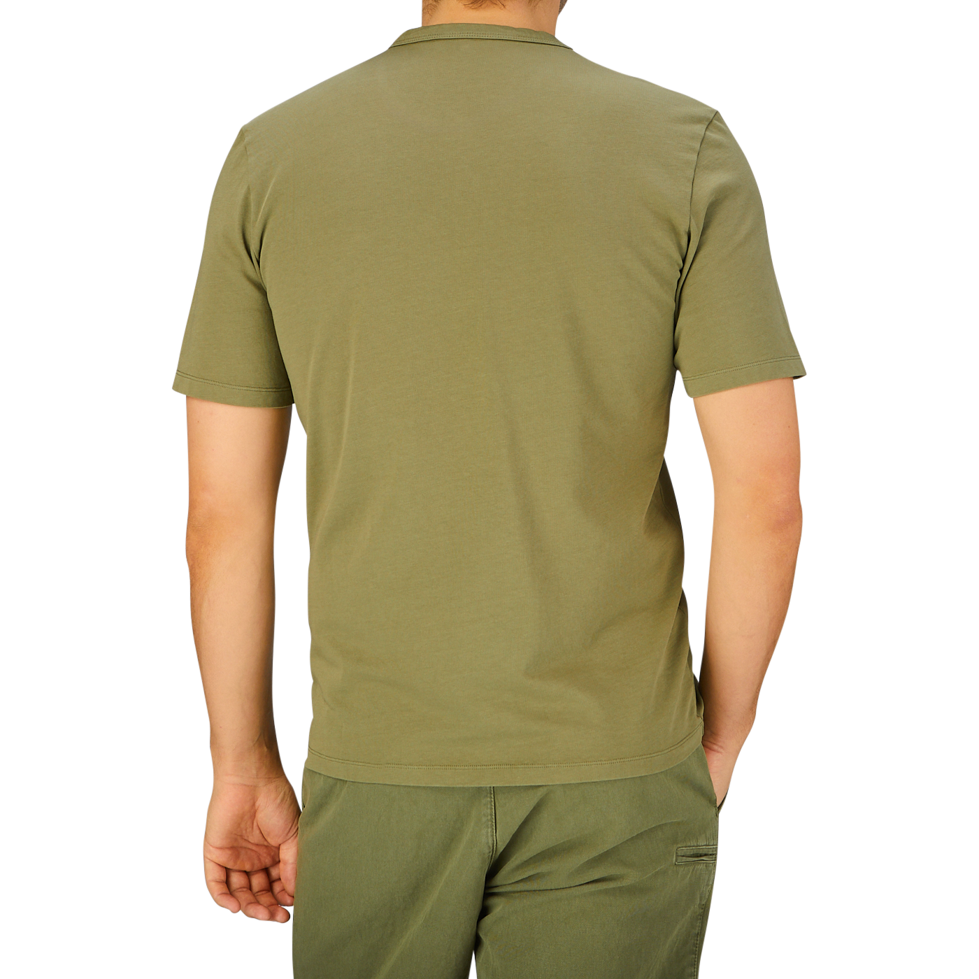 Man standing with his back facing the camera, wearing a plain olive green Tela Genova Green Heavy Organic Cotton T-Shirt and matching pants.