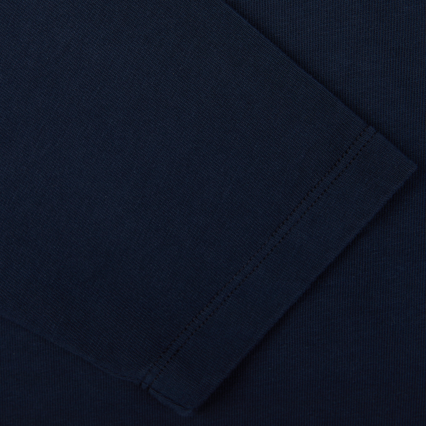 Close-up view of Tela Genova's Navy Blue Heavy Organic Cotton LS T-Shirt, highlighting its dark blue fabric with visible stitching and texture, showcasing elements of garment construction. This piece reflects heritage clothing craftsmanship.