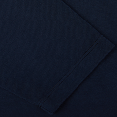 Close-up view of Tela Genova's Navy Blue Heavy Organic Cotton LS T-Shirt, highlighting its dark blue fabric with visible stitching and texture, showcasing elements of garment construction. This piece reflects heritage clothing craftsmanship.