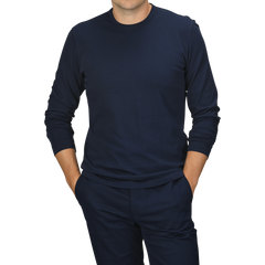 A person wearing a Navy Blue Heavy Organic Cotton LS T-Shirt by Tela Genova and matching pants stands with hands in their pockets against a plain background.