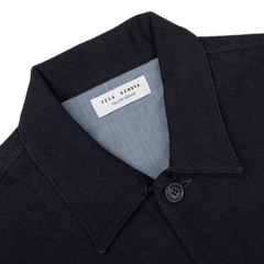 Close-up of a dark denim shirt featuring a label inside the collar that reads "Tela Genova," providing a sophisticated casual vibe similar to the Navy Blue Wool Cotton Greto Overshirt.