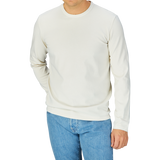Man wearing a Off-White Heavy Organic Cotton LS T-Shirt by Tela Genova and blue jeans by Tela Genova.