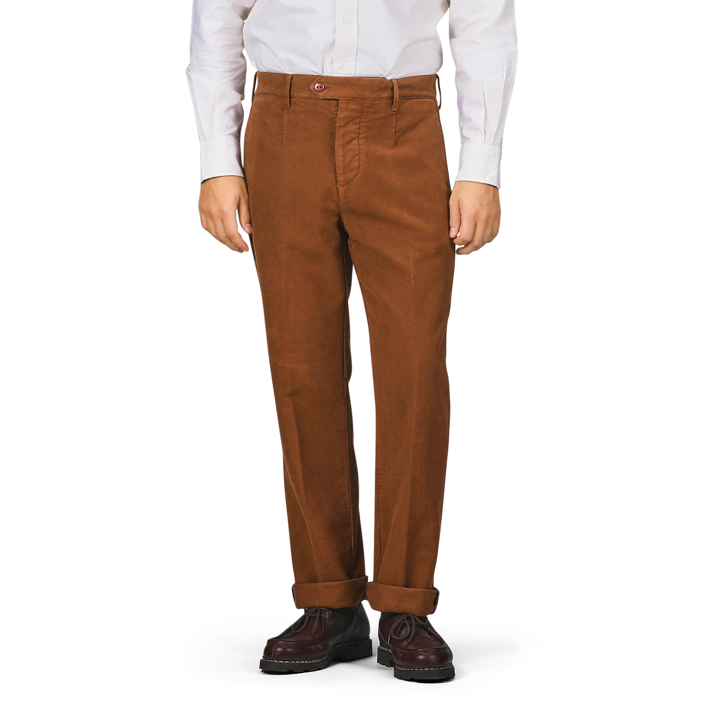 A person wearing Tela Genova's Tobacco Brown Cotton Moleskin Berardo Trousers, paired with a white shirt and brown shoes, stands against a plain background.