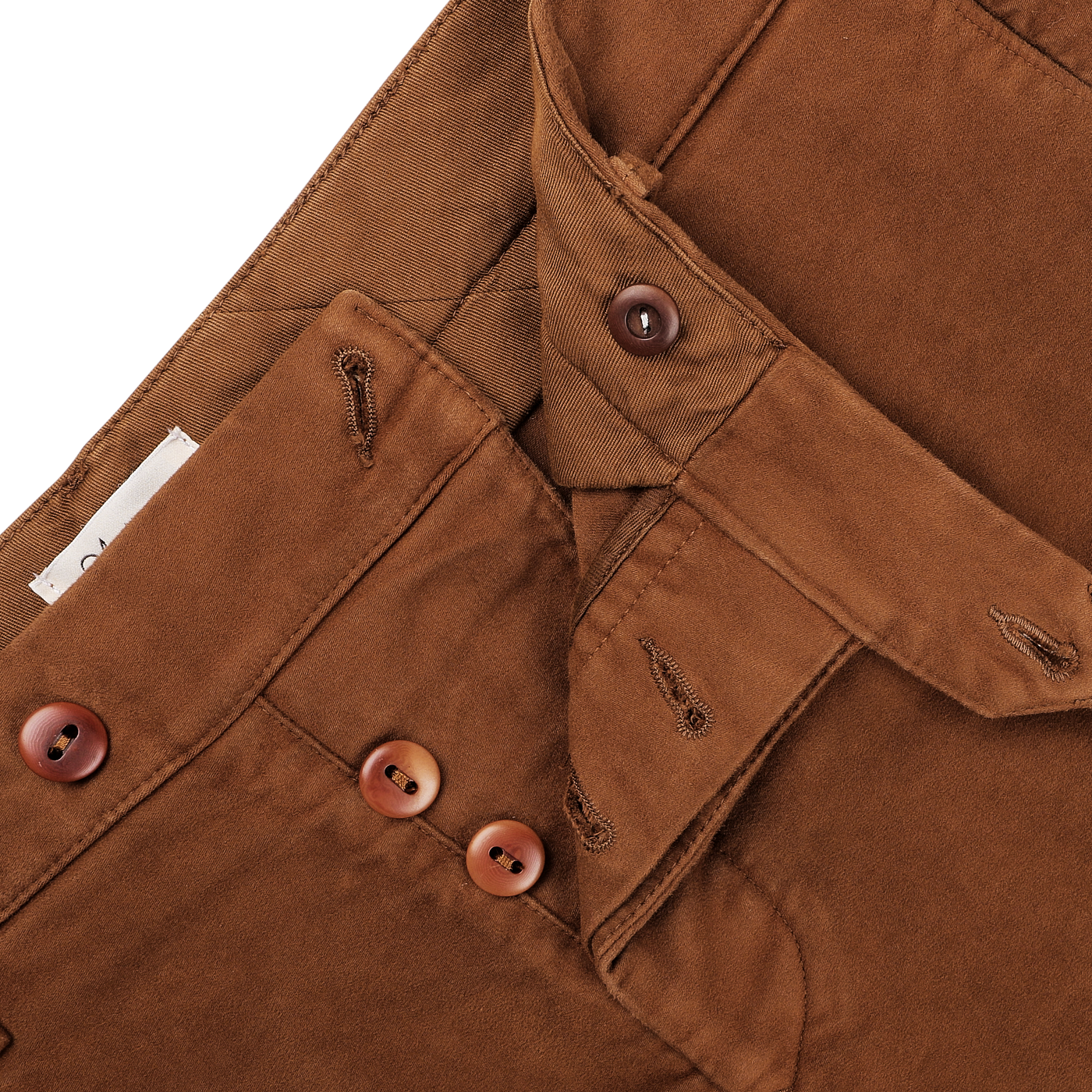 Close-up of Tela Genova's Tobacco Brown Cotton Moleskin Berardo Trousers, featuring a button fly detail that highlights the precise stitching and buttonholes. These trousers are crafted from cotton moleskin for a refined touch and exceptional durability.