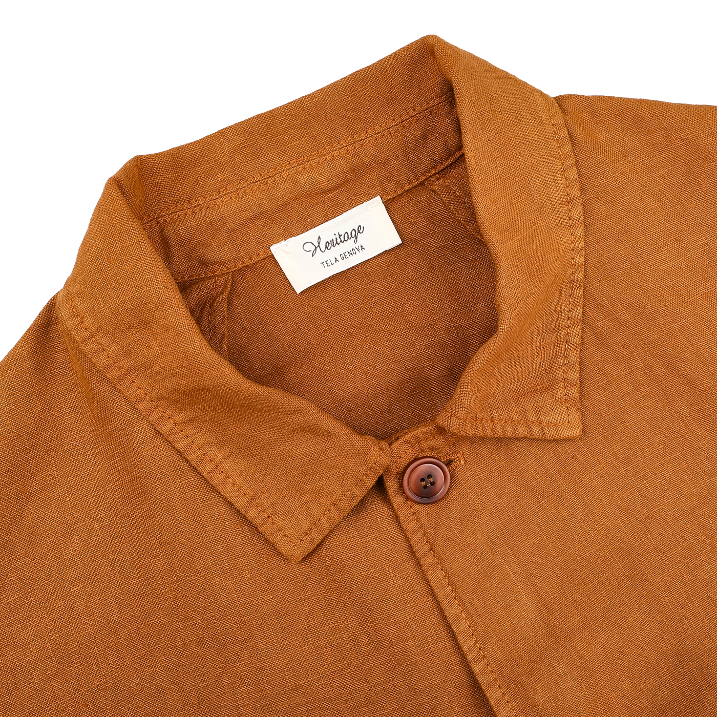 The Tobacco Pure Linen Camillo Jacket from Tela Genova features a brown, button-up design with a collar and a single visible button, ideal for casual wear. Inside, the "Heritage Flaxseed" label guarantees quality pure linen.