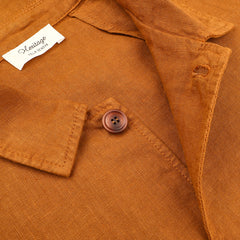 Close-up of the Tobacco Pure Linen Camillo Jacket by Tela Genova, featuring a brown button and a white "Heritage Tailored" label, ideal for a casual look.