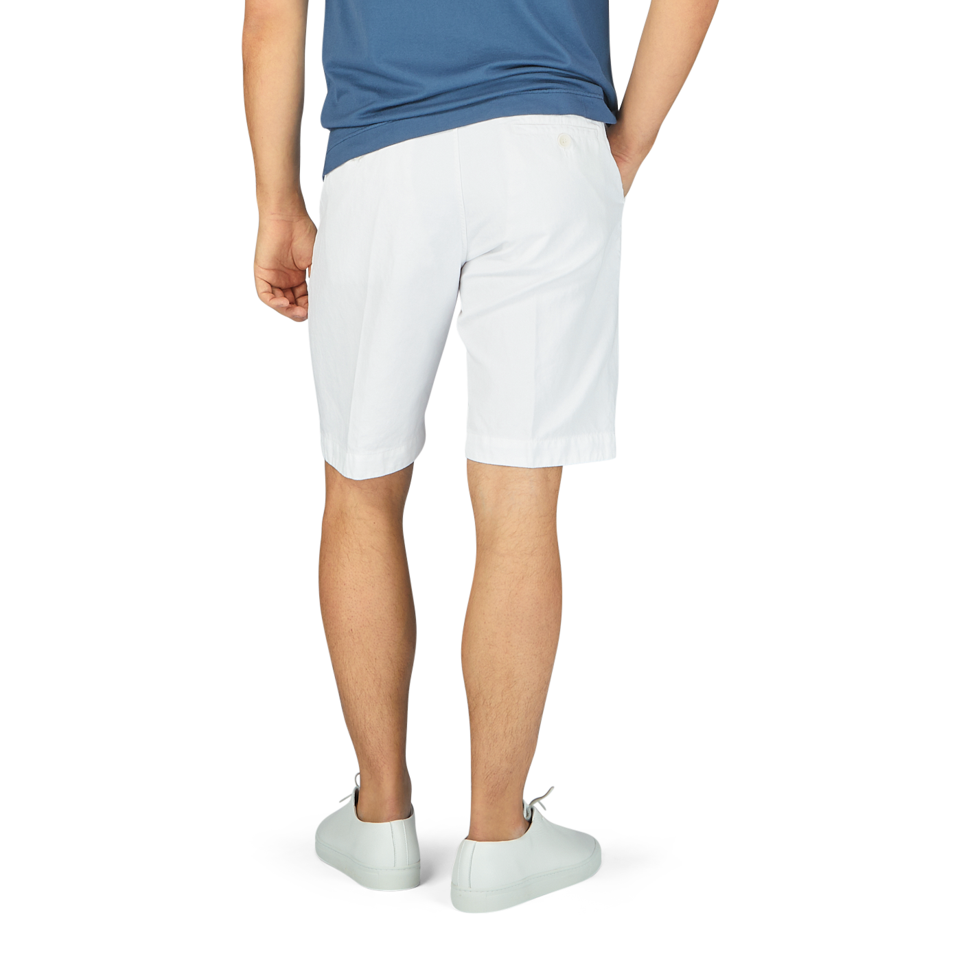 The man is wearing White Cotton Linen Bermuda Shorts and a blue shirt by Tela Genova.