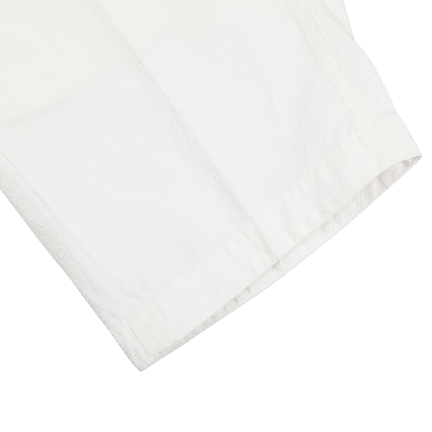 A close up image of a Tela Genova white cotton linen Bermuda shorts.