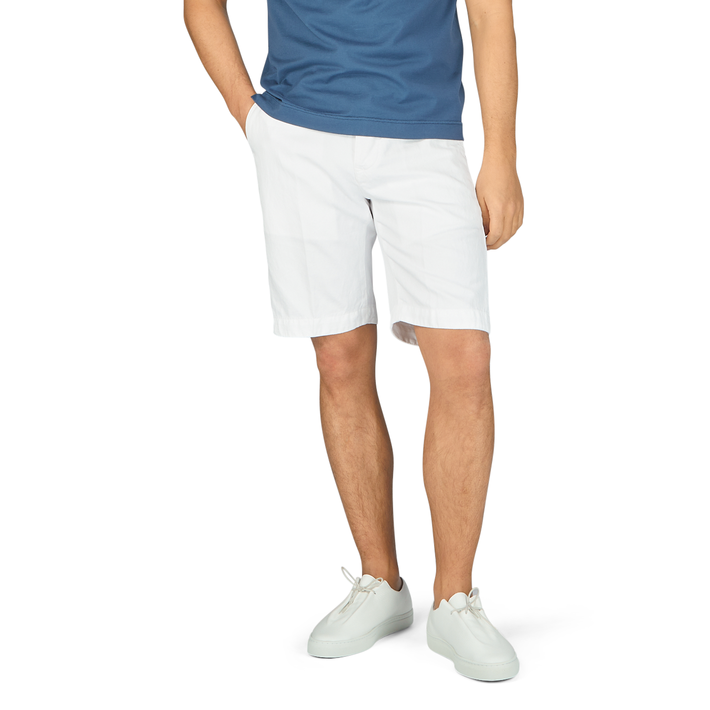 A man wearing Tela Genova white cotton linen Bermuda shorts and a blue t-shirt.