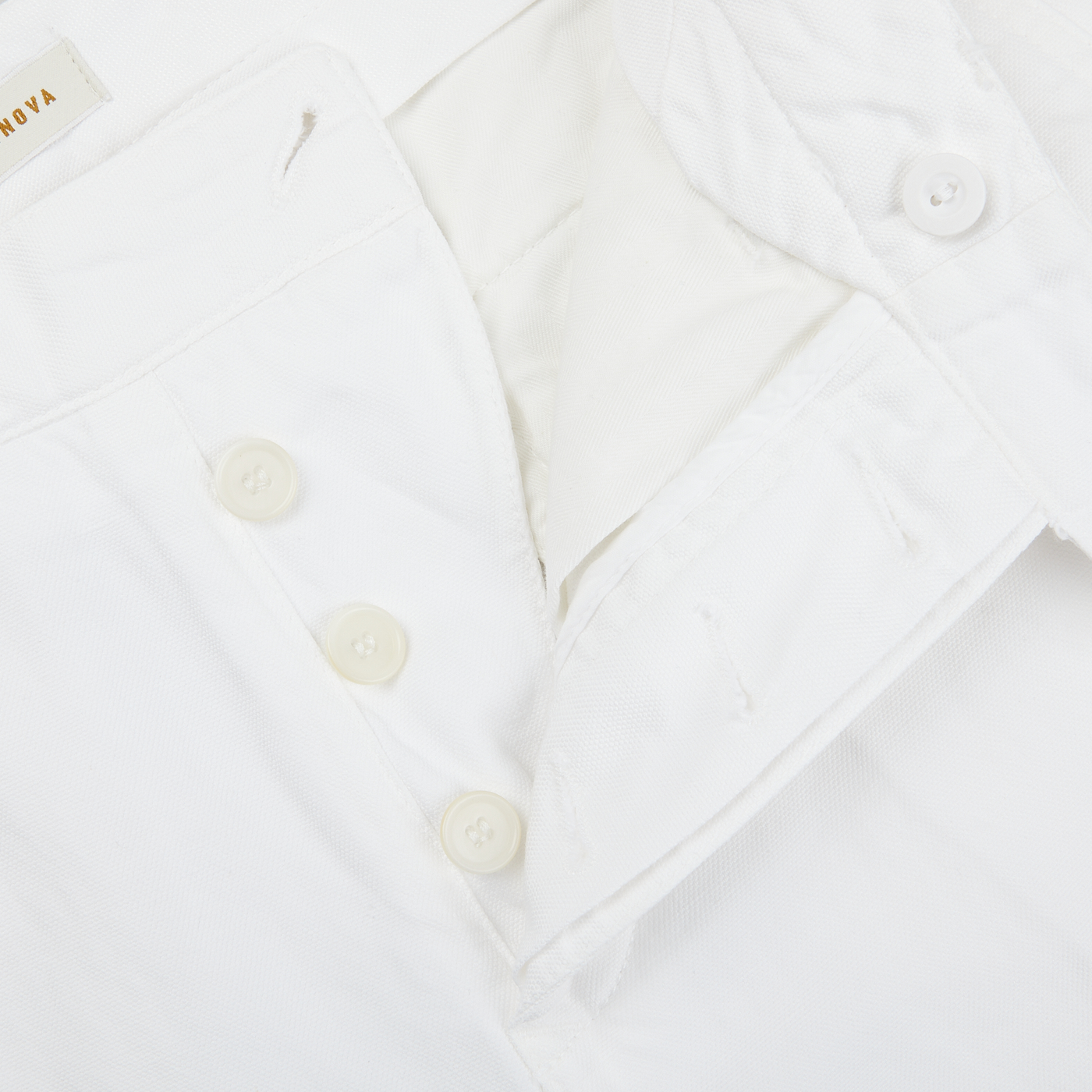 A close up image of Tela Genova White Cotton Linen Bermuda Shorts with buttons.