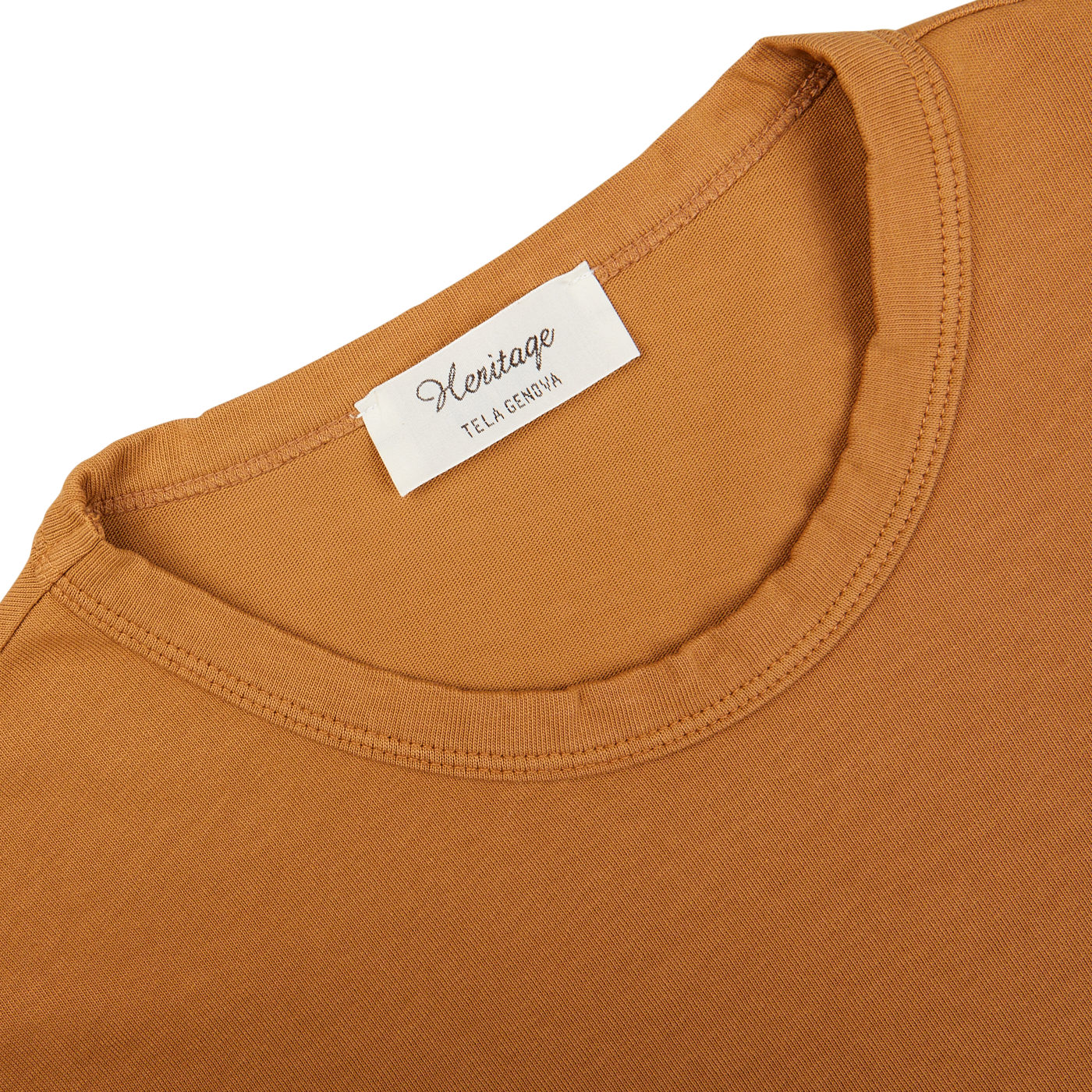 Close-up of a Brick Orange Heavy Organic Cotton T-Shirt's neckline with a Tela Genova white brand label, made from organic cotton.